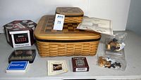 Full lot overview showing both Longaberger baskets, poker chip rack, and playing card decks