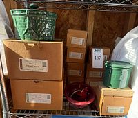 Shelf with boxed crocks, green crock displayed, green salt crock visible