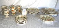 Overall view of cups, saucers, plates, bowls, platter