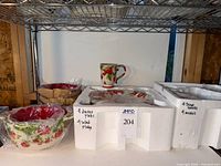 Set in original foam insert showing mug, plates, bowls