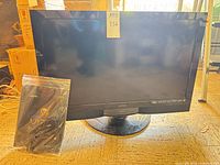 Front view of Vizio SV320XVT TV with accessories bag