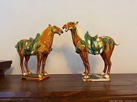 Both sancai glazed horse figurines front view
