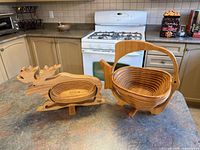Both bamboo collapsible baskets standing open on countertop