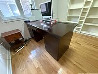 Front angled view showing full desk, pedestal drawers, right panel support, surface finish