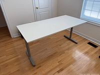 Full view of white desk with silver legs