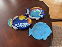 Three plate designs displayed on table