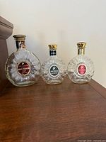 All three empty Rémy Martin glass bottles side by side