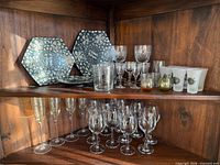 Overall view of two wooden shelves with all lot items