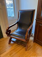 Front angled view of hardwood and leather armchair