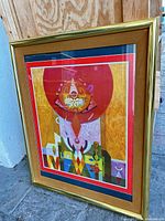 Full view of framed abstract print in gold frame