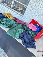 Tote with nylon bags spread on floor displaying colours