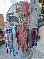 Front view of two rows of assorted ties hanging on fan