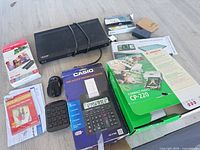 Group view of all electronics including printer box, Blu-ray player, calculator, mouse, keypad and refill packs