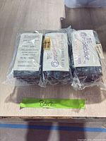 Three sealed packages of nitrile gloves with labels visible