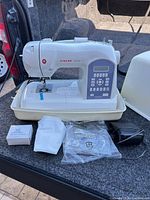Singer Stylist II 5625 sewing machine with all accessories displayed including case lid, foot pedal, accessory box, and bag of parts