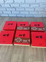 Six red mooncake boxes arranged on floor