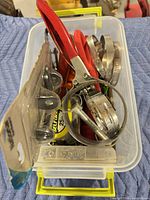 overview of bin filled with assorted tools and hose clamps
