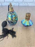 Two perfume atomizers side by side