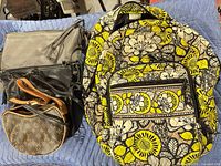 Vera Bradley backpack and three purses together