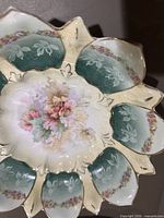 Top view porcelain flower-shaped bowl showing floral center and teal panels