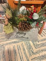 Front view showing galvanized envelope, Merry Christmas text and floral arrangement