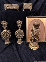 Group shot of all filigree vanity items including perfume bottles, boxes, figurine, and frame