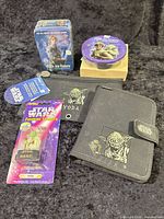 Group shot of all Star Wars items including metal card sets, Yoda stamper, planner and pencil case