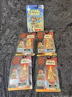 Front view of all five Yoda action figures showing card fronts and accessories