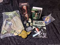 Overview of lot showing puppet, boxed figures, book, coin and mini figures