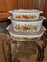 Stacked view showing three casserole dishes with pattern and lids