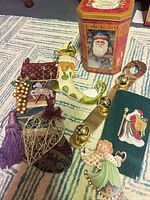 Group shot of all items including tin, ornaments, towel, bell strap