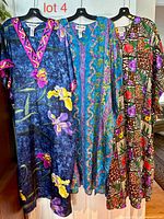 Front view of all three caftans on hangers