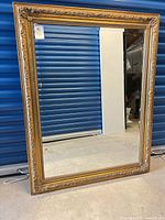 Full view of rectangular mirror with ornate gold frame