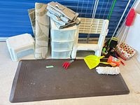 Group shot of all items including drying rack, storage tower, mat, rug, cleaning tools and accessories