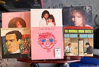 Overview of stacked LPs showing several identifiable titles