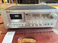 Front view of Alpage FL-2000 showing cassette well, VU meters, transport buttons and controls