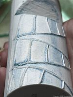 Detail of incised geometric decoration with blue glaze on vase surface
