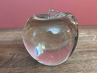 front view of clear glass apple paperweight showing stem and overall form