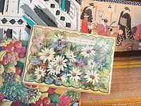 Stack of assorted placemats showing floral, fruit, Japanese, abstract, woven designs