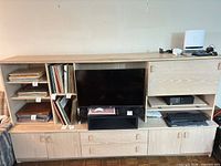 Front view of entertainment unit with shelves, TV bay, cupboards and drawers closed