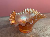 Overall view of marigold carnival glass hat vase with ruffled rim