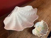 Top view of both shell-form bowls showing size difference and decoration