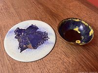 Bowl and plaque together on wood surface