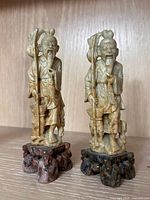 Front view of both carved hardstone scholar figures on bases
