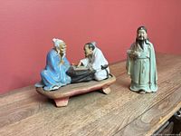 Both figurine pieces displayed together on table