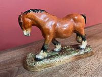 Left side view of Royal Doulton Shire horse figurine showing chestnut glaze and black mane