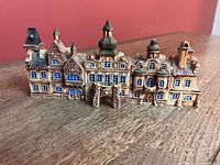 Front view of five glazed ceramic buildings forming streetscape