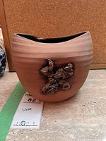 Front view of vase showing applied driftwood relief and overall form