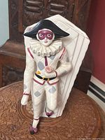 Front view showing Harlequin figure and vase body