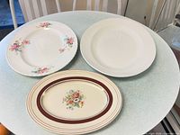 Three oval platters grouped on table showing overall designs